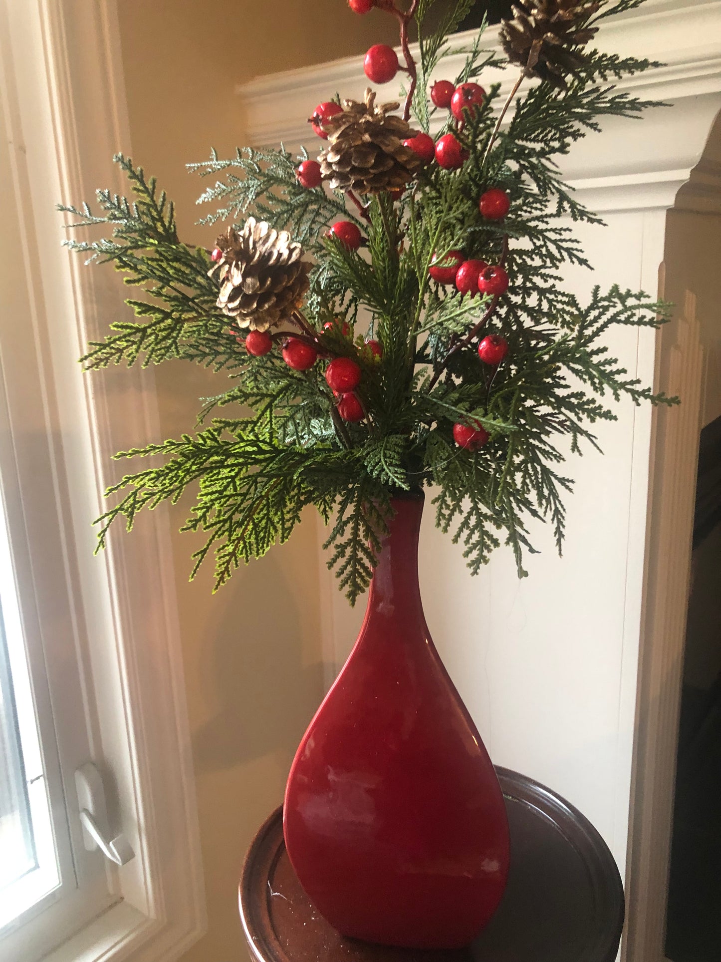 Holiday Arrangement with Greens and Berries in Red Tall Vase*Store Pick Up Only