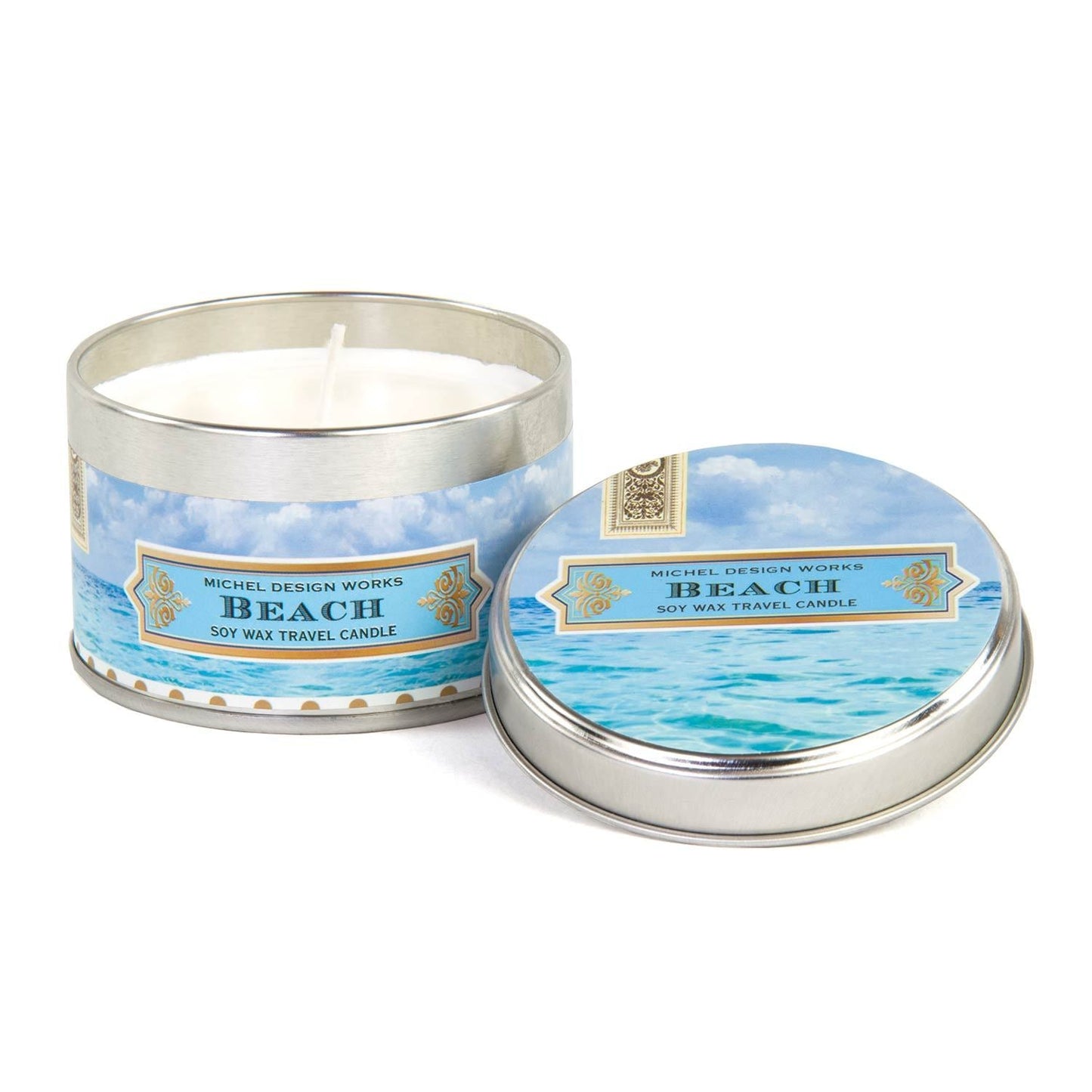 Small beach scented candle in a silver tin with waves and blue beach inspire label 